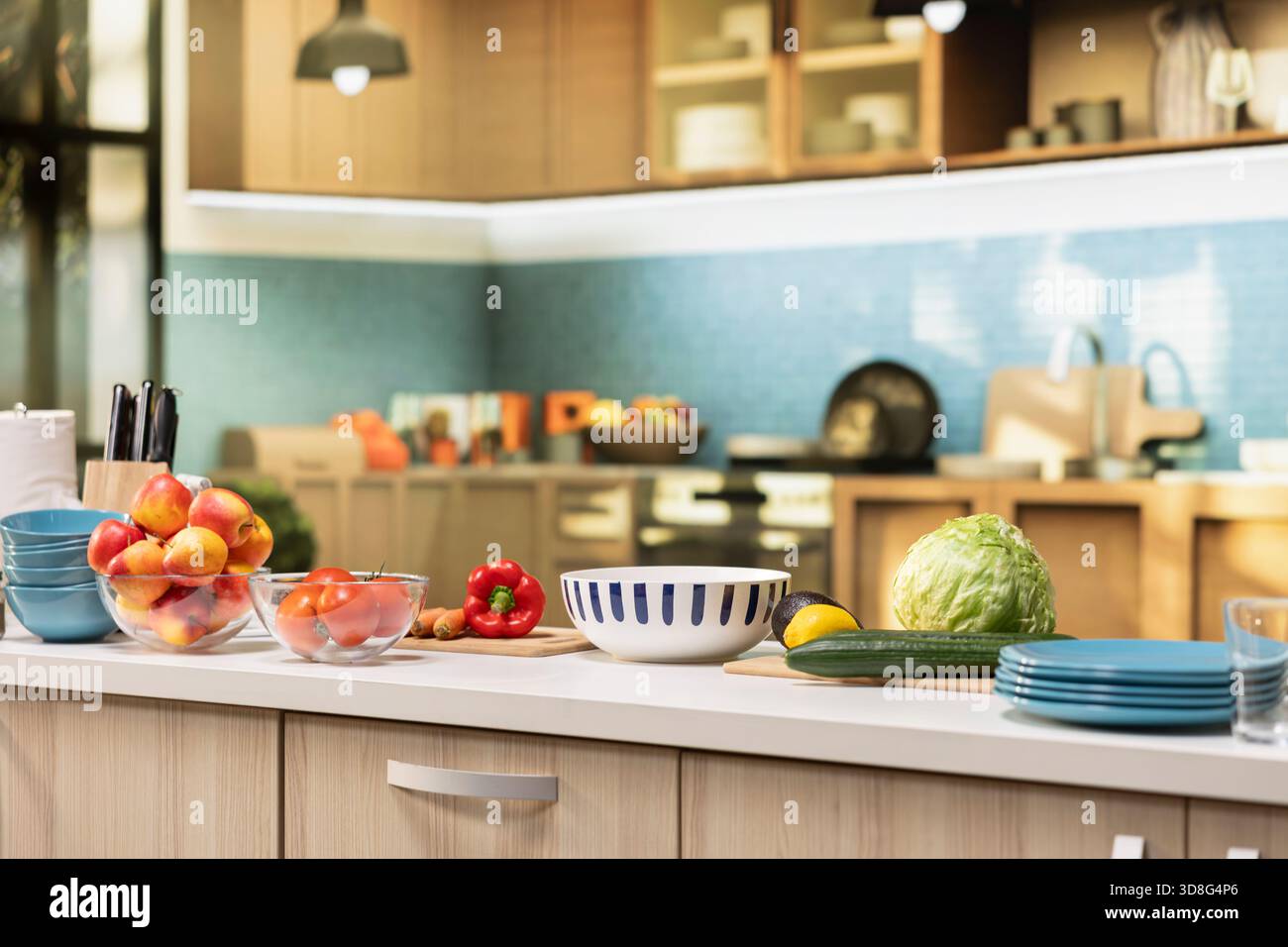 Bright modern kitchen interior with elegant furniture and wooden cupboards. Cookware and fresh vegetables on a cutting board, showcasing a stylish household and luxury home design. Stock Photo