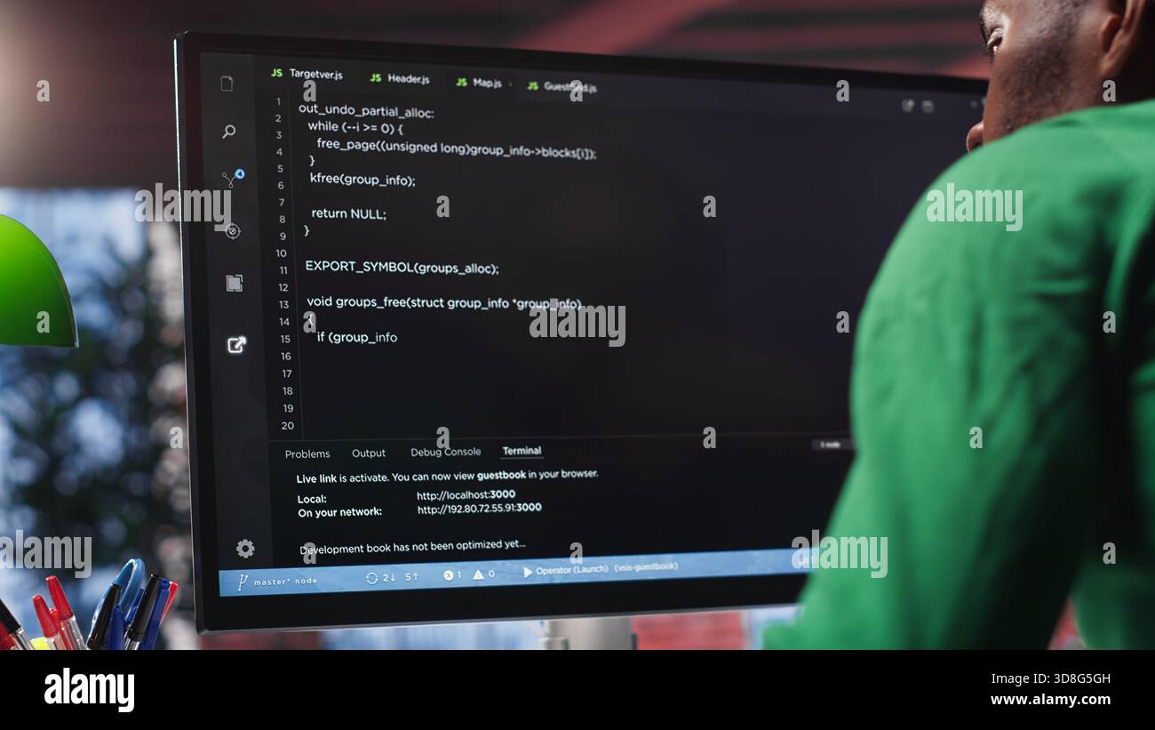 Black system administrator creating a software with programming language. Professional engineer focuses on app development, debugging, encryption and security at home. Camera A. Stock Photo