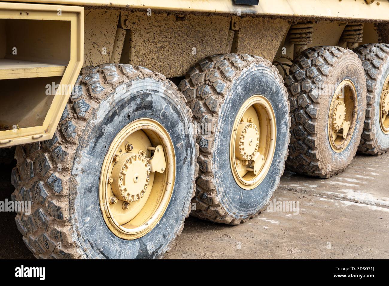 Close-up view of large rugged wheels and tires on a military armored ...