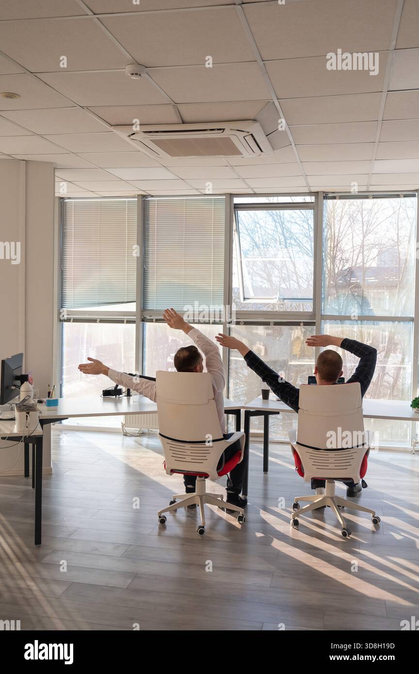 Two Caucasian men having fun at work Stock Photo - Alamy