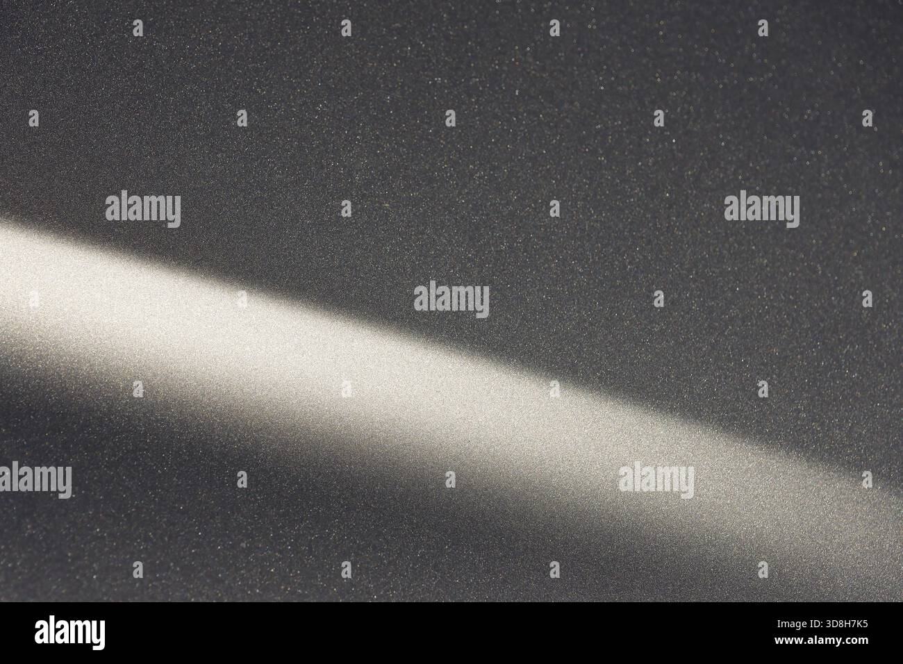 Calm abstract background showing diagonal ray of light on dark grey texture. This minimal, simple, modern pattern with shadow effect creates serene mo Stock Photo