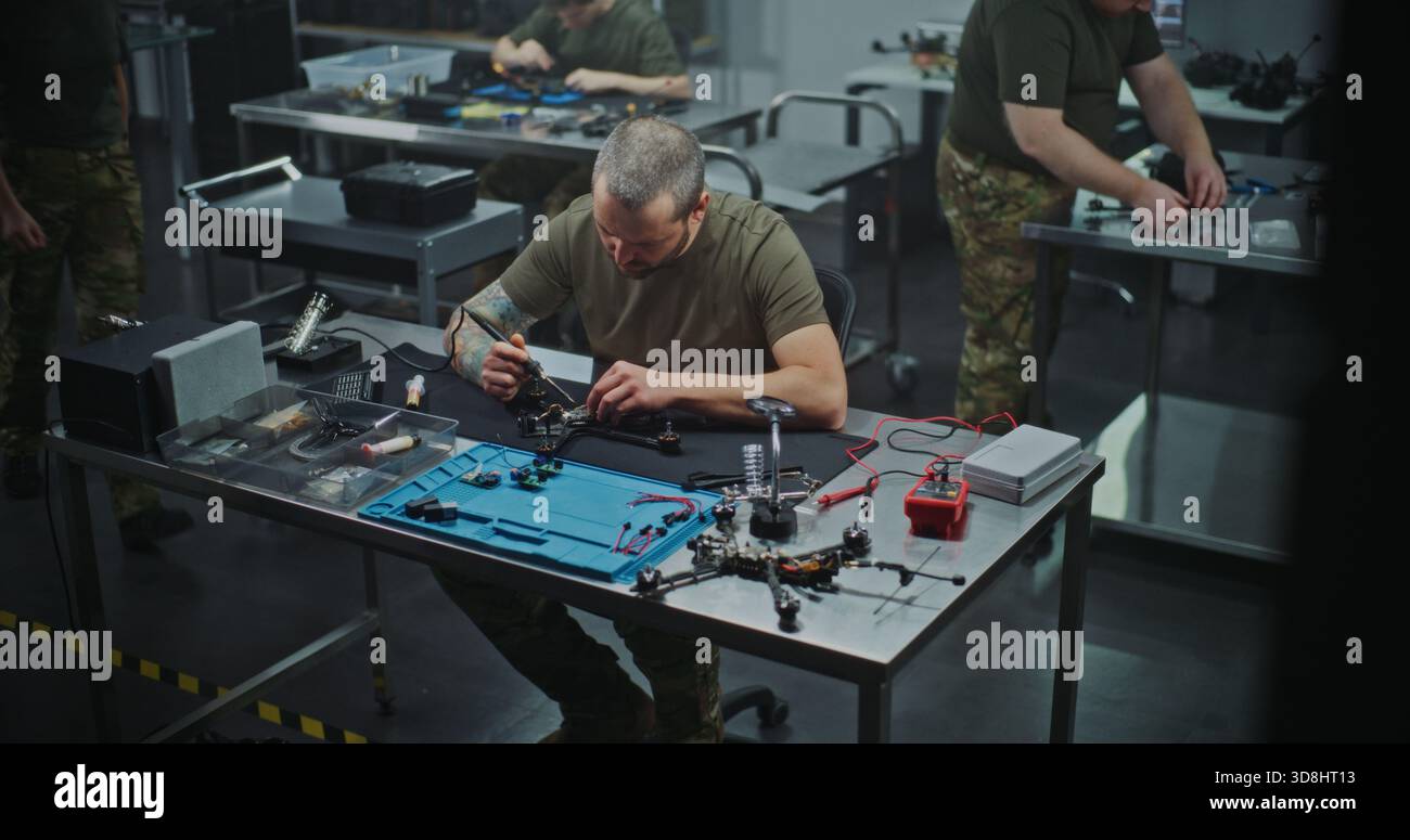 Technician Performing Intricate Repair and Maintenance FPV Drone Electronics, Using Soldering Iron. Concept of Technical Service and Complexity of Drone Maintenance, Troubleshooting, Refining drone. Stock Photo