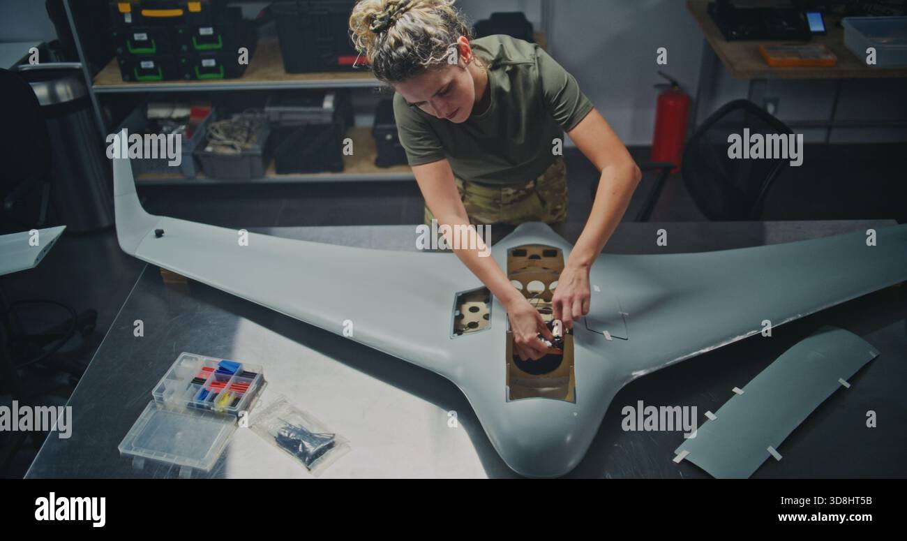 Well Lit, Organized Drone Factory Features Several Stations Where Engineers Assembling Large UAVs. Concept of Assembly For UAV, Streamlined, Systematic Approach to Modern Defense Production. Top View. Stock Photo