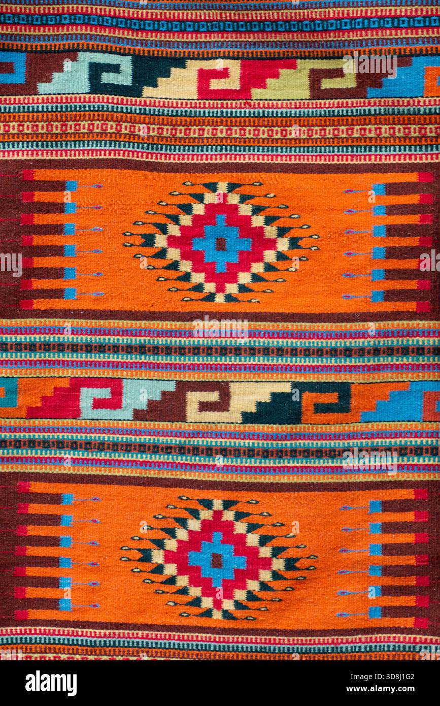 Detailed close-up of a vibrant woven textile featuring geometric shapes ...