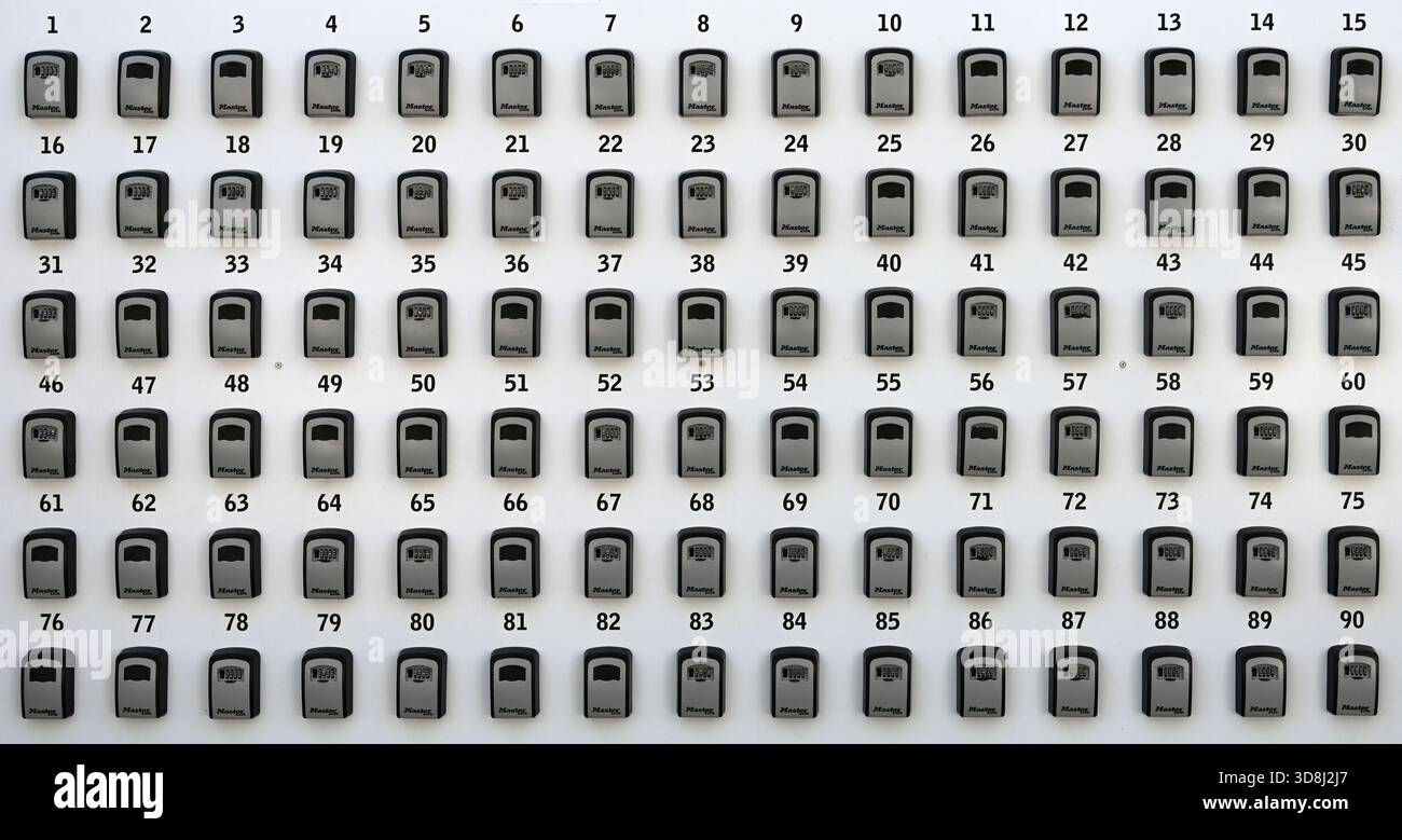 Lines or Rows of Numbered Key Boxes, Lock Boxes or Security Boxes. Ninety Key Boxes Stock Photo