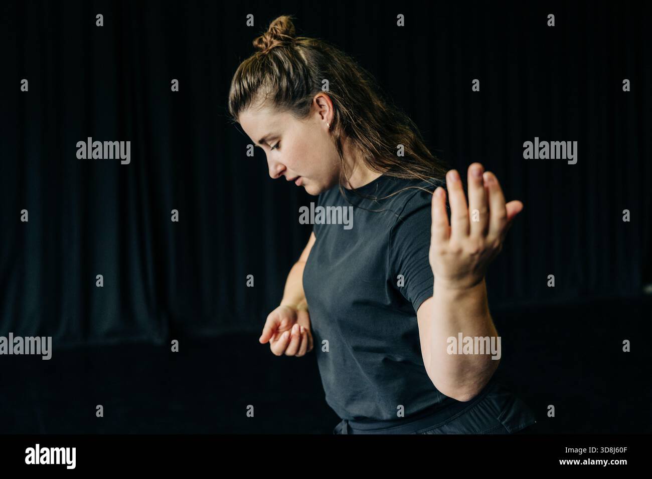 Woman practicing contemporary dance during rehearsal Stock Photo