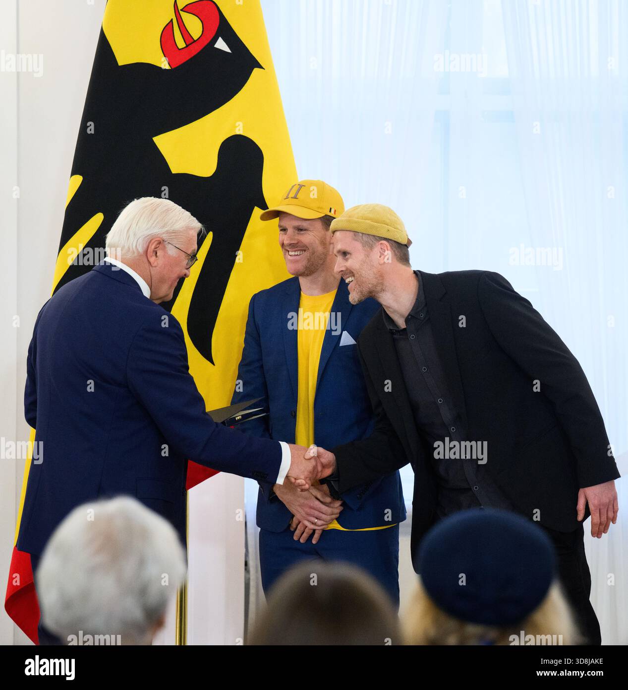 Berlin, Germany. 01st Dec, 2025. Federal President Frank-Walter Steinmeier awards Felix Neumann from Kehl and Till Neumann (r) from Freiburg im Breisgau (Baden-Württemberg) the Order of Merit of the Federal Republic of Germany at Bellevue Palace. Under the motto 'Germany in the World', the Federal President is today awarding 11 women and 9 men the Order of Merit for their outstanding commitment on International Volunteer Day on December 5. Credit: Bernd von Jutrczenka/dpa/Alamy Live News Stock Photo