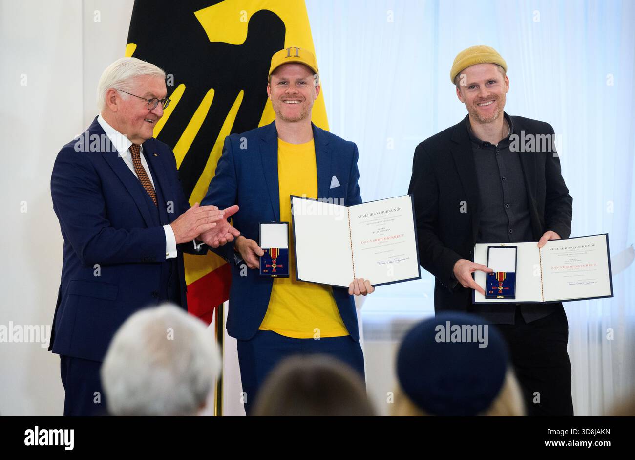 Berlin, Germany. 01st Dec, 2025. Federal President Frank-Walter Steinmeier awards Felix Neumann from Kehl and Till Neumann (r) from Freiburg im Breisgau (Baden-Württemberg) the Order of Merit of the Federal Republic of Germany at Bellevue Palace. Under the motto 'Germany in the World', the Federal President is today awarding 11 women and 9 men the Order of Merit for their outstanding commitment on International Volunteer Day on December 5. Credit: Bernd von Jutrczenka/dpa/Alamy Live News Stock Photo