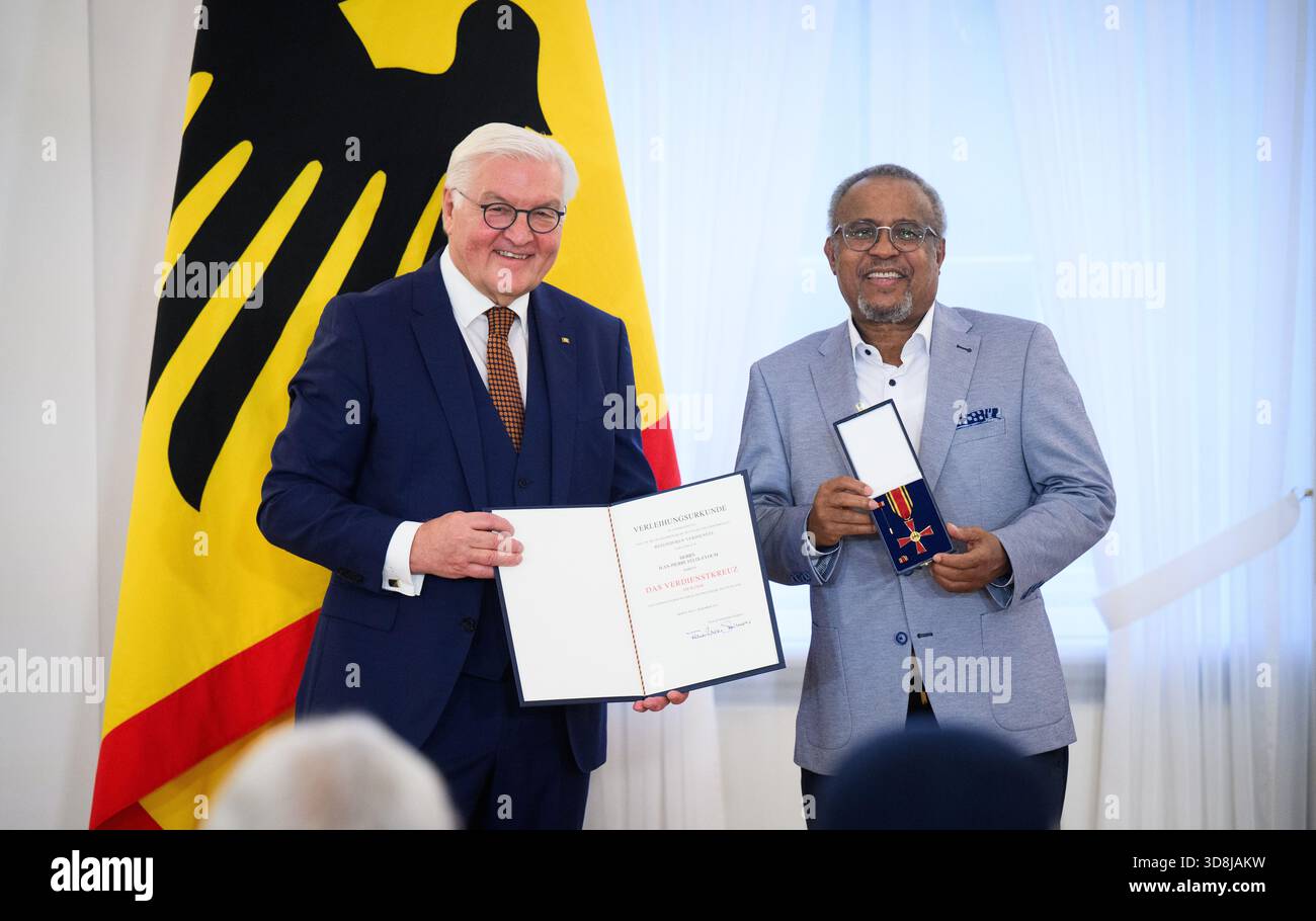 Berlin, Germany. 01st Dec, 2025. Federal President Frank-Walter Steinmeier awards Jean-Pierre Félix-Eyoum from Dorfen (Bavaria) the Order of Merit of the Federal Republic of Germany at Bellevue Palace. Under the motto 'Germany in the World', the Federal President is today awarding the Order of Merit to 11 women and 9 men for their outstanding commitment on International Volunteer Day on December 5. Credit: Bernd von Jutrczenka/dpa/Alamy Live News Stock Photo