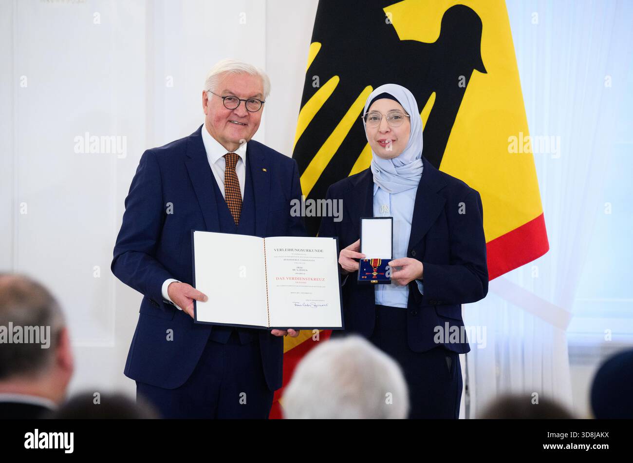 Berlin, Germany. 01st Dec, 2025. Federal President Frank-Walter Steinmeier awards Du'A Zeitun from Osnabrück (Lower Saxony) the Order of Merit of the Federal Republic of Germany at Bellevue Palace. Under the motto 'Germany in the World', the Federal President is today awarding the Order of Merit to 11 women and 9 men for their outstanding commitment on International Volunteer Day on December 5. Credit: Bernd von Jutrczenka/dpa/Alamy Live News Stock Photo