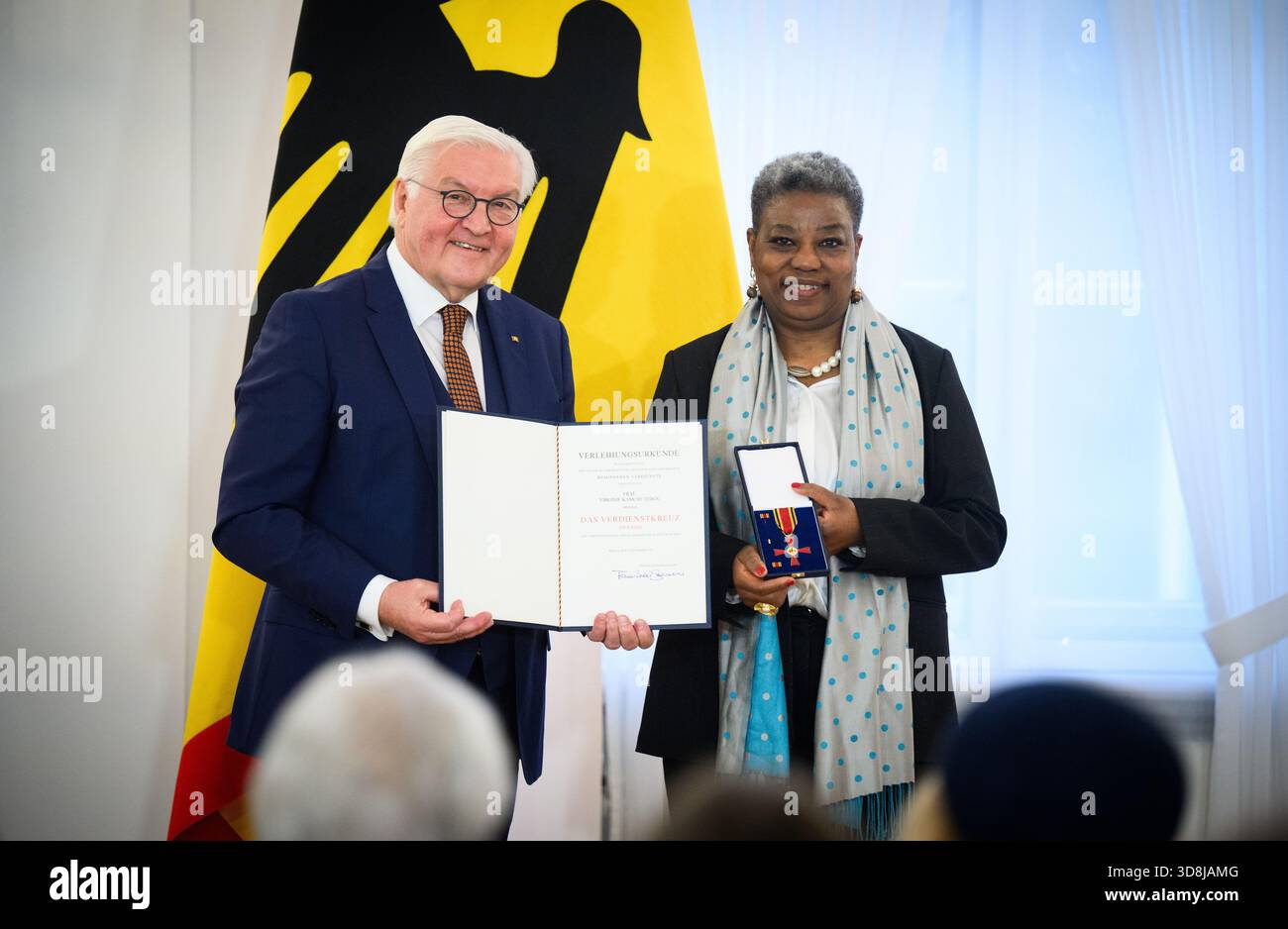 Berlin, Germany. 01st Dec, 2025. Federal President Frank-Walter Steinmeier awards Virginie Kamche Tebou from Bremen the Order of Merit of the Federal Republic of Germany at Bellevue Palace. Under the motto 'Germany in the World', the Federal President is today awarding the Order of Merit to 11 women and 9 men for their outstanding commitment on International Volunteer Day on December 5. Credit: Bernd von Jutrczenka/dpa/Alamy Live News Stock Photo