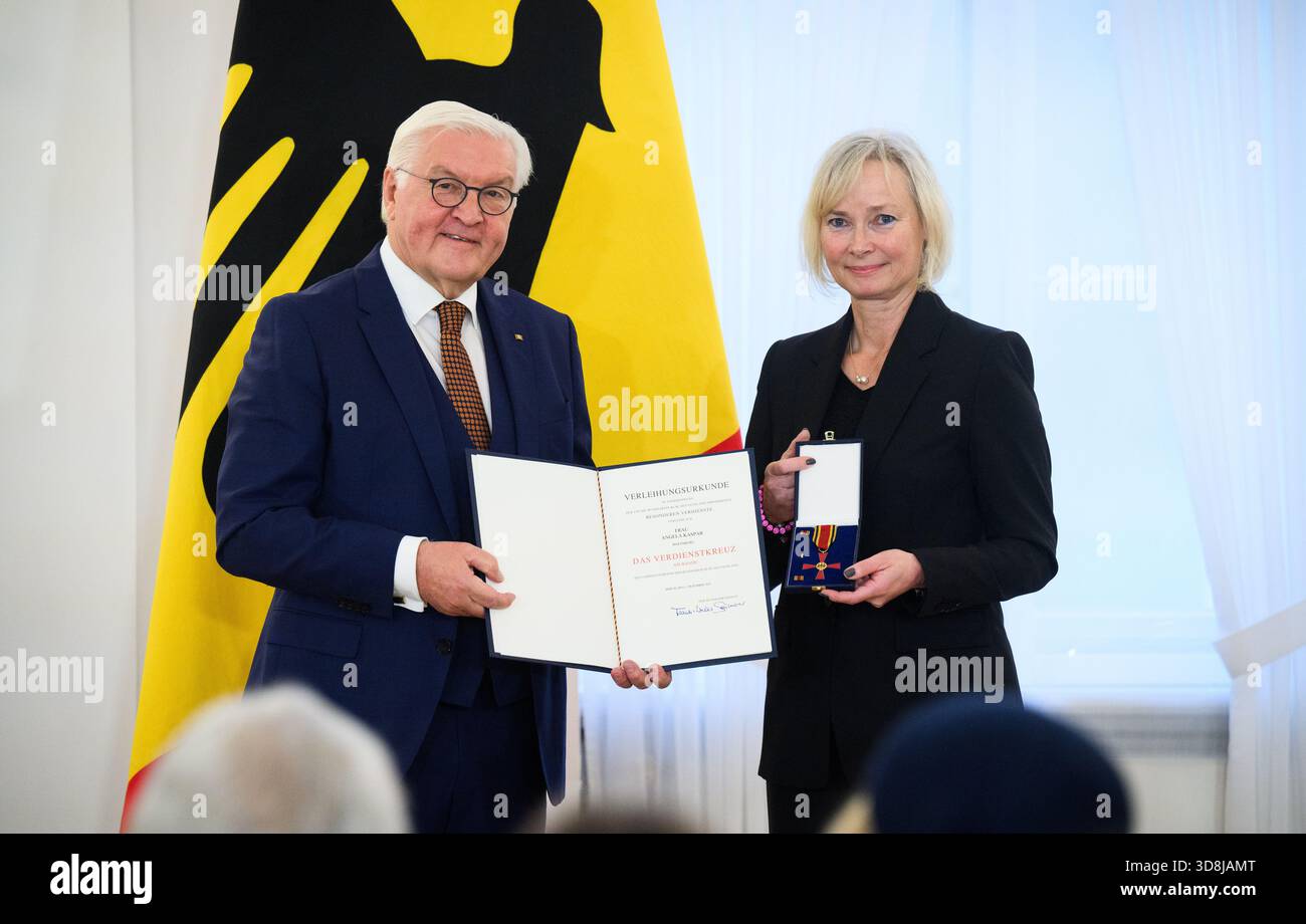 Berlin, Germany. 01st Dec, 2025. Federal President Frank-Walter Steinmeier awards Angela Kaspar from Wolfsburg (Lower Saxony) the Order of Merit of the Federal Republic of Germany at Bellevue Palace. Under the motto 'Germany in the World', the Federal President is today awarding the Order of Merit to 11 women and 9 men for their outstanding commitment on International Volunteer Day on December 5. Credit: Bernd von Jutrczenka/dpa/Alamy Live News Stock Photo