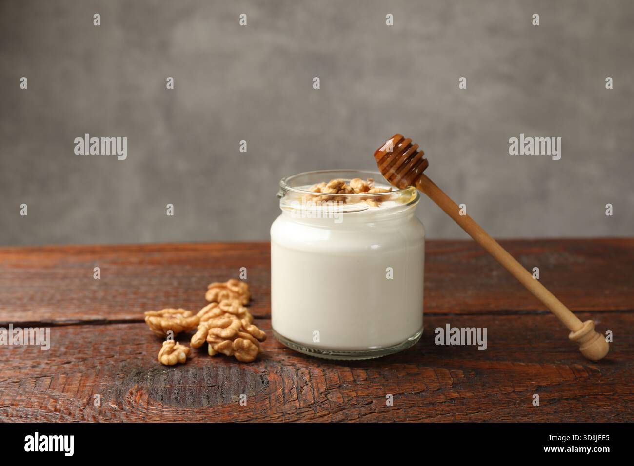Delicious Greek yogurt with honey and nuts on wooden table. Space for ...