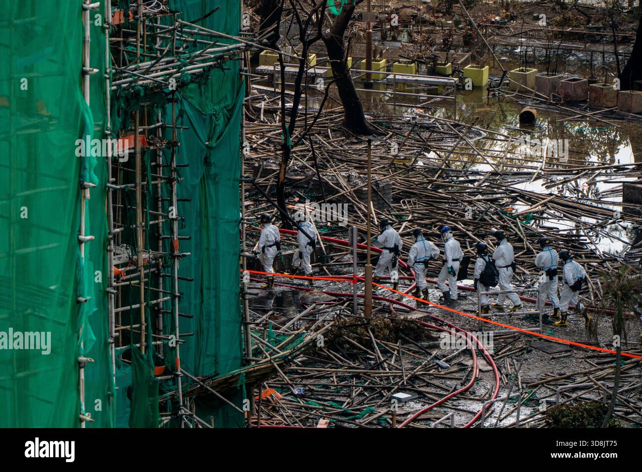 Hong Kong. 1 Dec, 2025. Police officers entering one of the burned buildings at Wang Fuk Court housing complex in Tai Po following a deadly fire on December 1, 2025 in Hong Kong. (Photo by Vernon Yuen/Nexpher Images) Credit: Nexpher Images Limited/Alamy Live News Credit: Nexpher Images Limited/Alamy Live News Stock Photo