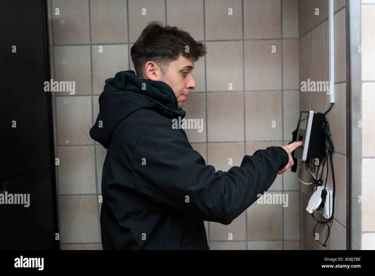 Man using a biometric reader for secure access control in a facility Stock Photo