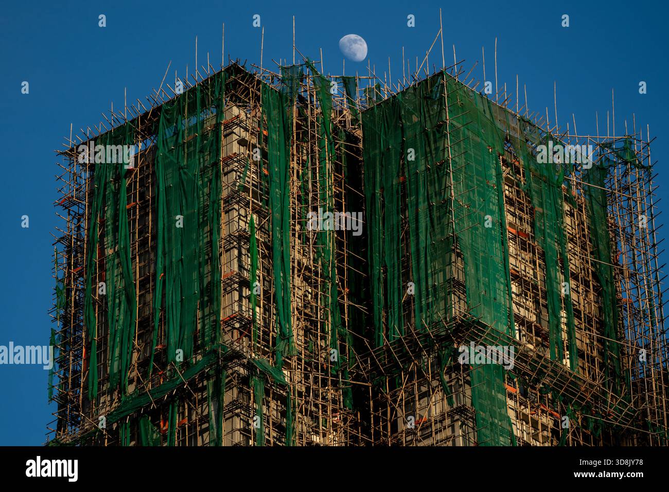 Hong Kong. 1 Dec, 2025. The moon on top one of the burned buildings near Wang Fuk Court housing complex in Tai Po following a deadly fire on December 1, 2025 in Hong Kong. (Photo by Vernon Yuen/Nexpher Images) Credit: Nexpher Images Limited/Alamy Live News Credit: Nexpher Images Limited/Alamy Live News Stock Photo