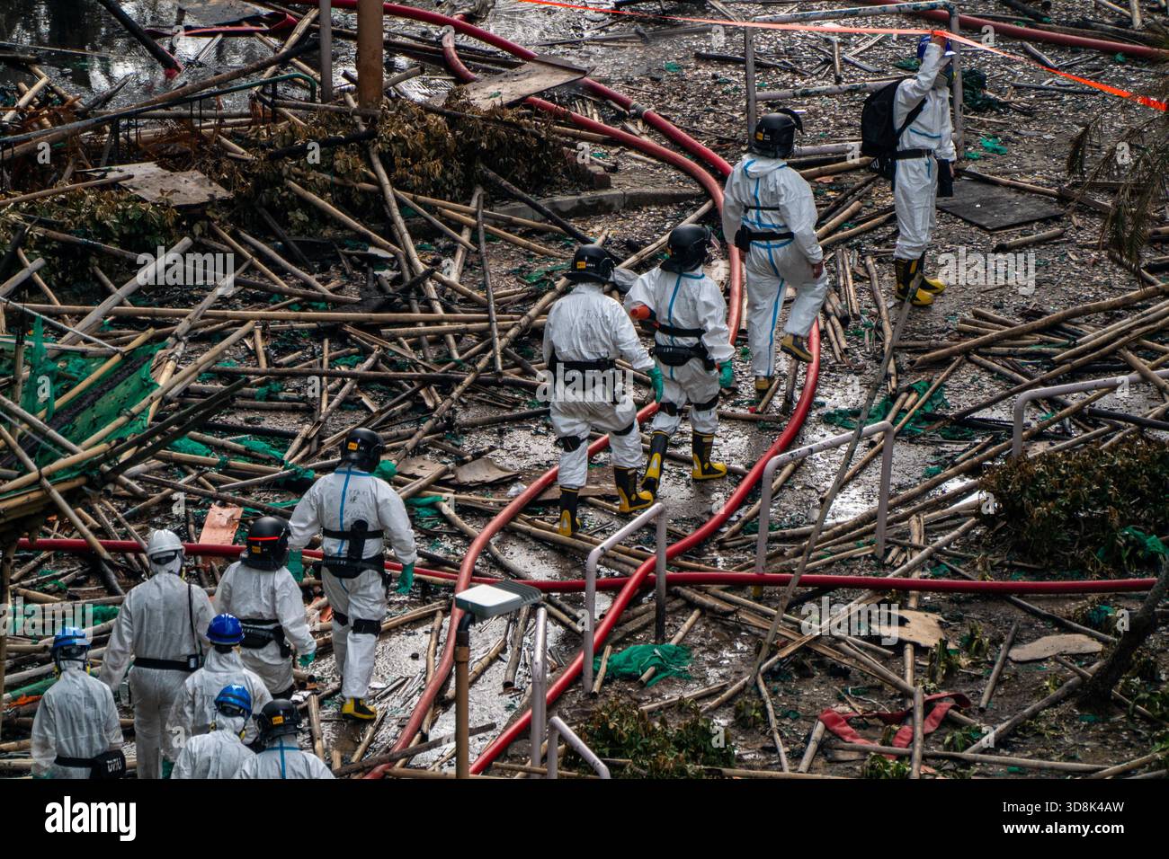 Hong Kong. 1 Dec, 2025. Police officers entering one of the burned buildings at Wang Fuk Court housing complex in Tai Po following a deadly fire on December 1, 2025 in Hong Kong. (Photo by Vernon Yuen/Nexpher Images) Credit: Nexpher Images Limited/Alamy Live News Credit: Nexpher Images Limited/Alamy Live News Stock Photo
