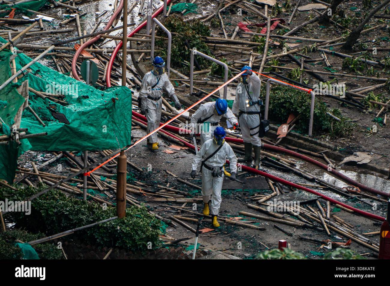 Hong Kong. 1 Dec, 2025. Police officers leaving one of the burned buildings at Wang Fuk Court housing complex in Tai Po following a deadly fire on December 1, 2025 in Hong Kong. (Photo by Vernon Yuen/Nexpher Images) Credit: Nexpher Images Limited/Alamy Live News Stock Photo