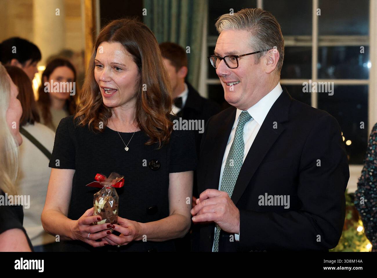 Lady Victoria Starmer, wife of Prime Minister Sir Keir Starmer (right), holds a sample of homemade chocolates as they host a Christmas market-style showcase for small firms and community champions in number 10 Downing Street, London. Picture date: Monday December 1, 2025. Stock Photo