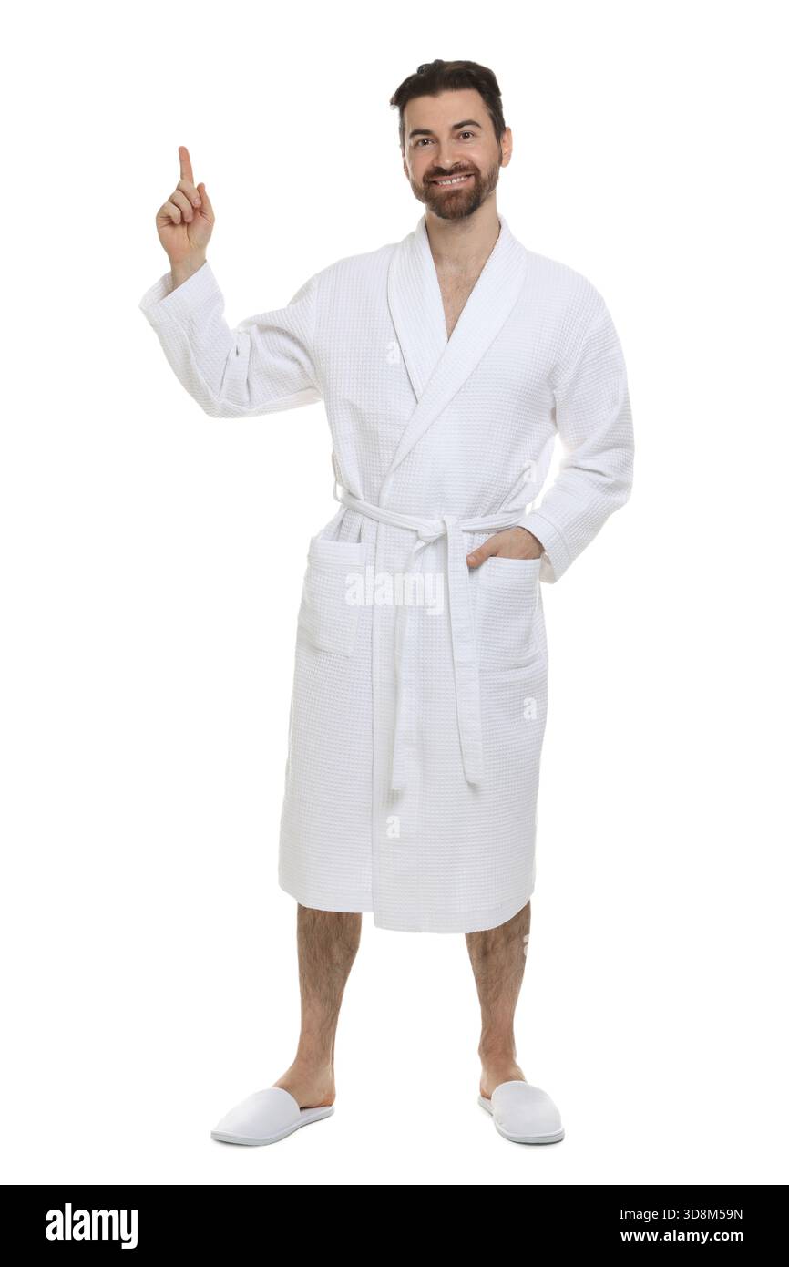 Man in bathrobe pointing at something on white background Stock Photo