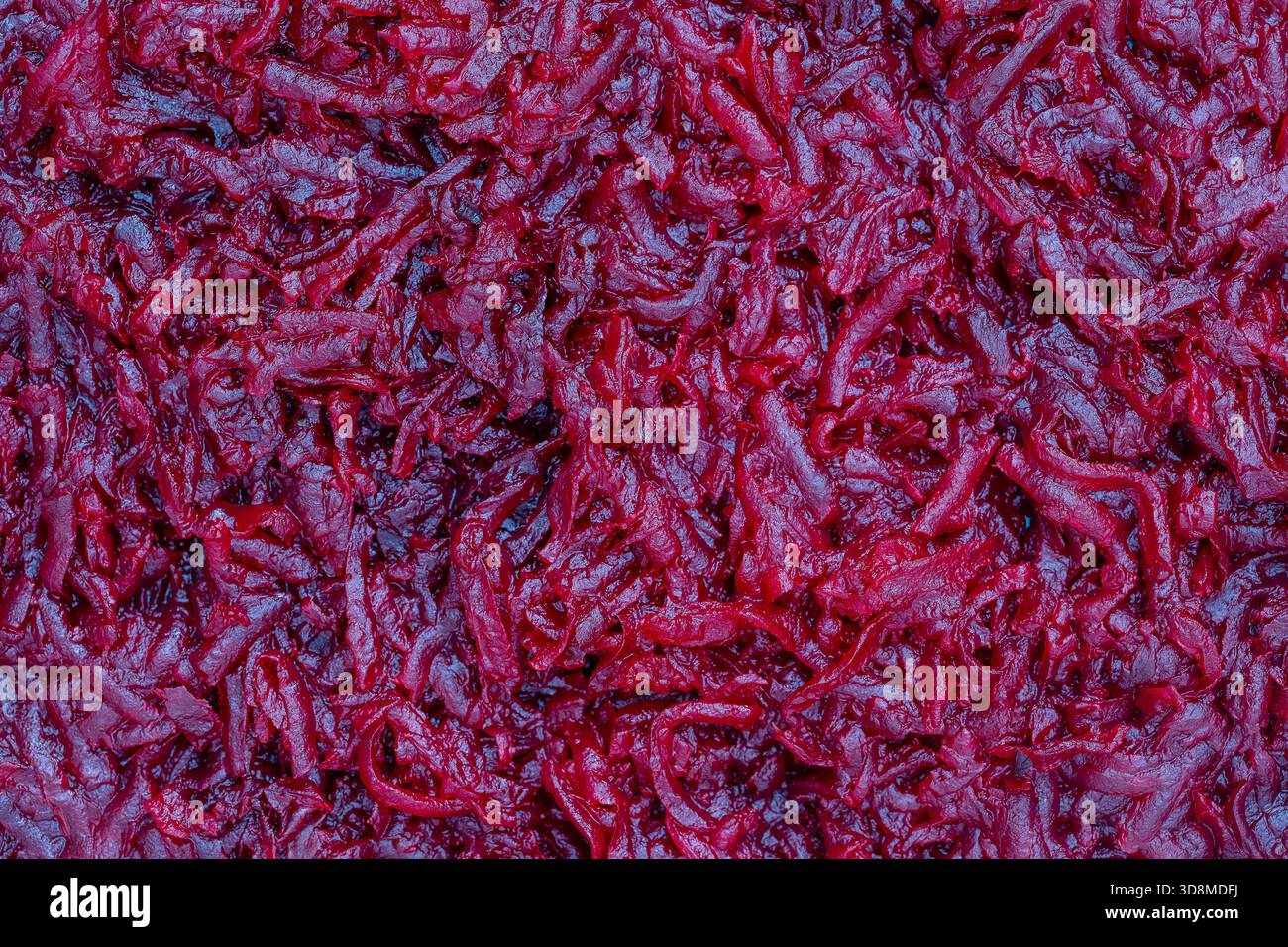Background and texture of raw fresh juicy grated red beetroot vegetable, close up, top view Stock Photo