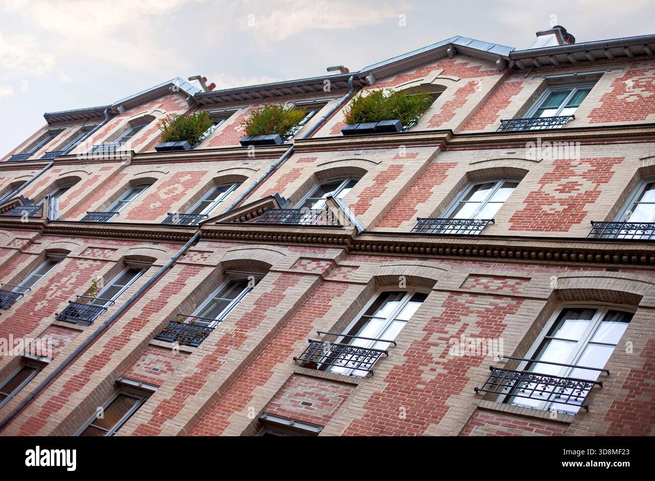Facade of an unusual brick building in Paris Stock Photo