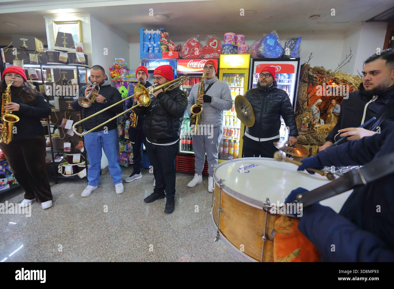 Young musicians play the night on the streets of the city to announce the start of the Christmas holidays. - Stock Image