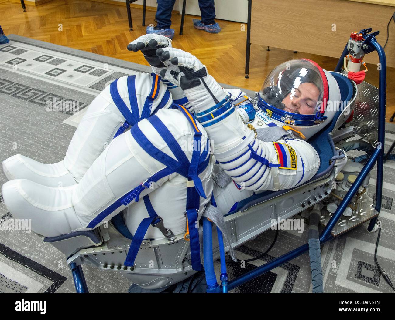 Baikonur , Kazakhstan. 27 November, 2025. Roscosmos cosmonaut Sergei Mikaev  has his Russian Sokol suit pressure checked as he and fellow crewmates,  NASA astronaut Chris Williams, and Roscosmos cosmonaut Sergey  Kud-Sverchkov,, prepare