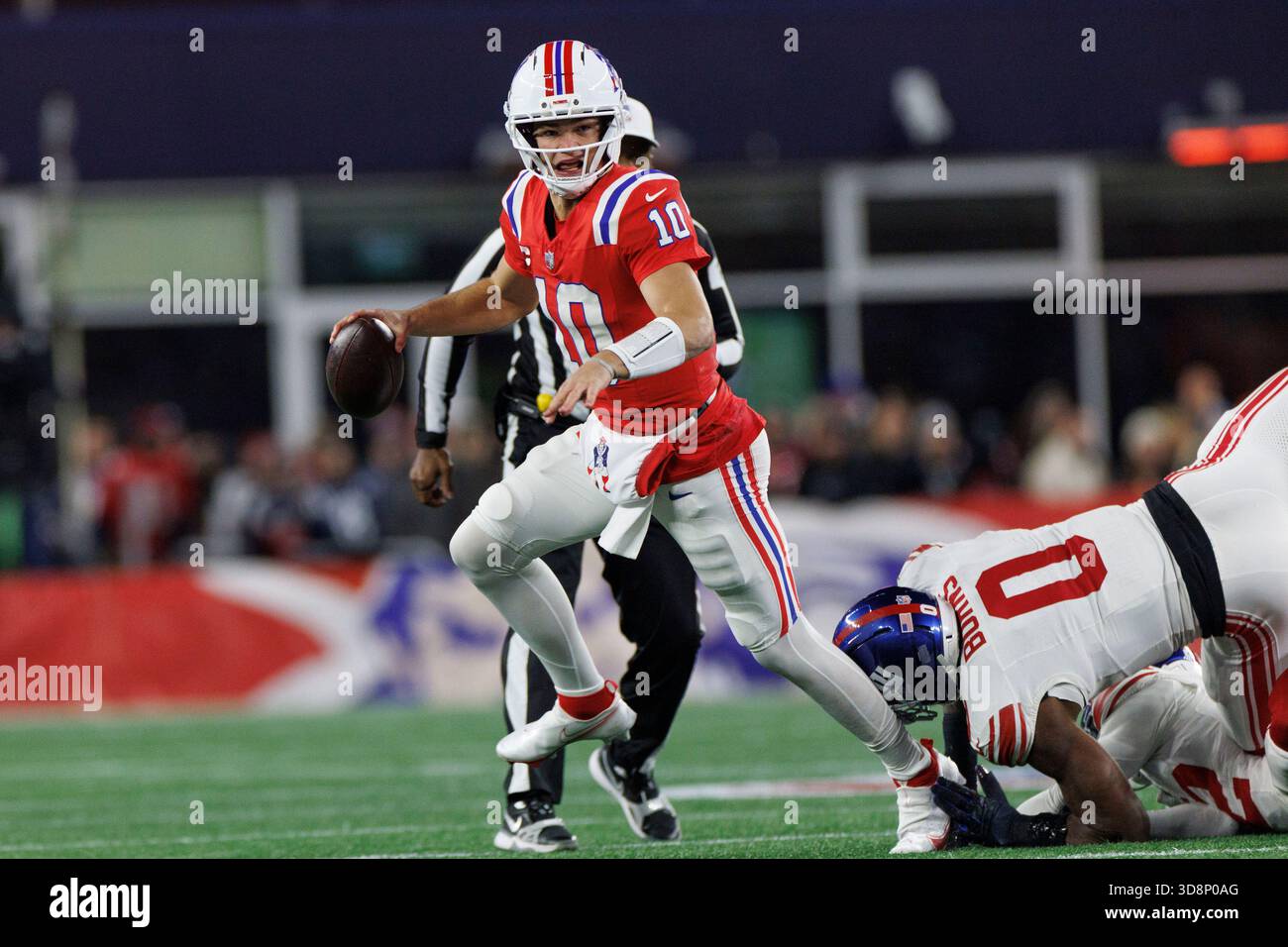 Foxborough, Massachusetts on Monday, December 01, 2025.New England Patriots quarterback Drake Maye (L) avoids the tackle of New York Giants linebacker Brian Burns (R) during the first half at Gillette Stadium in Foxborough, Massachusetts on Monday, December 01, 2025. Photo by CJ Gunther/UPI Credit: UPI/Alamy Live News Stock Photo