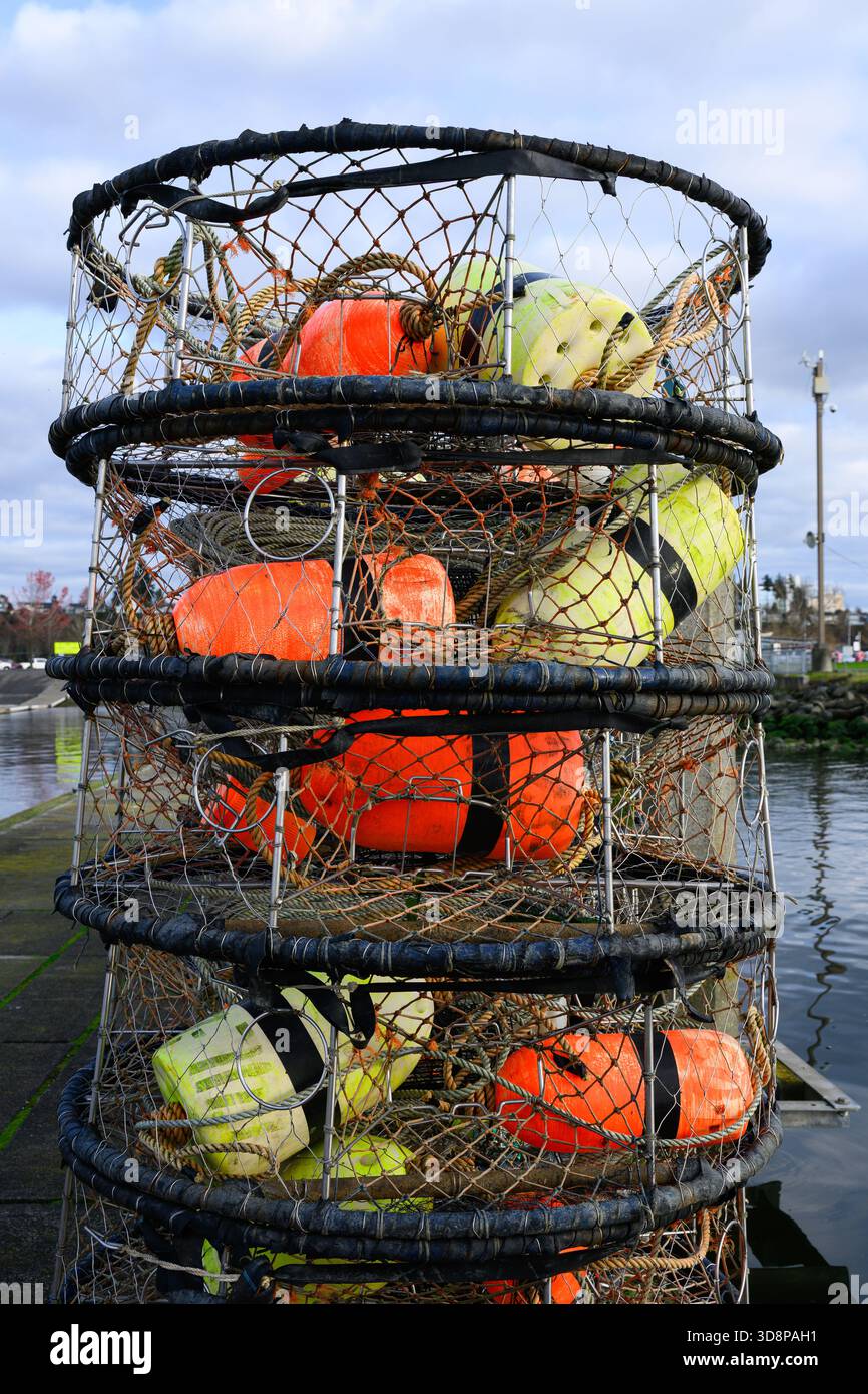 Pile of fishing crab pots with colored floats on pier Stock Photo - Alamy