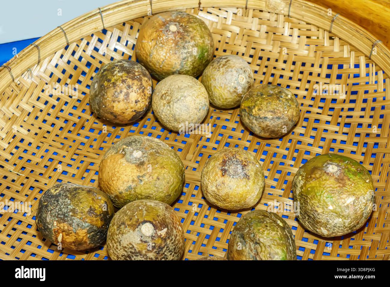 Basket of Feroniella lucida or Ma-sang fruits used as sour ingredient in Thai cuisine. Stock Photo