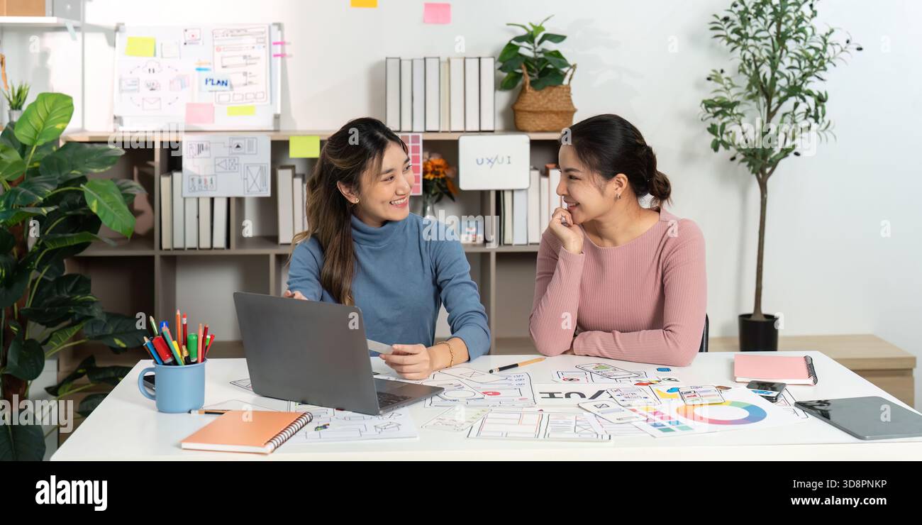 Friendly UX UI Designers Collaborating on Project Stock Photo
