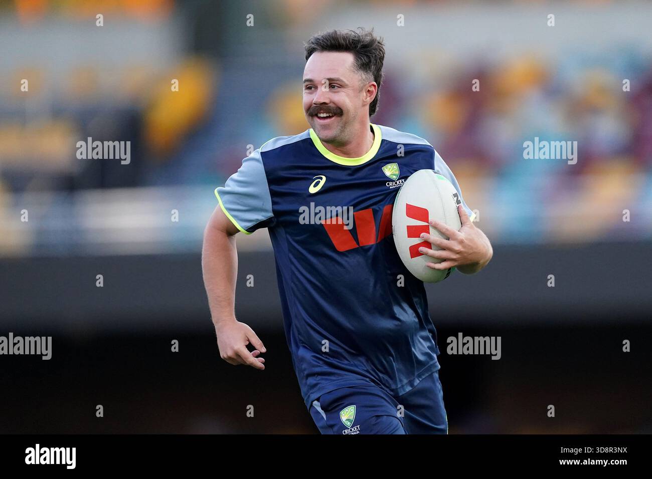 Australia's Travis Head runs with a rugby ball during a nets session at ...