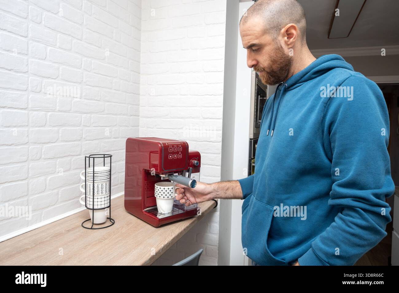 Man preparing coffee in his home kitchen Stock Photo