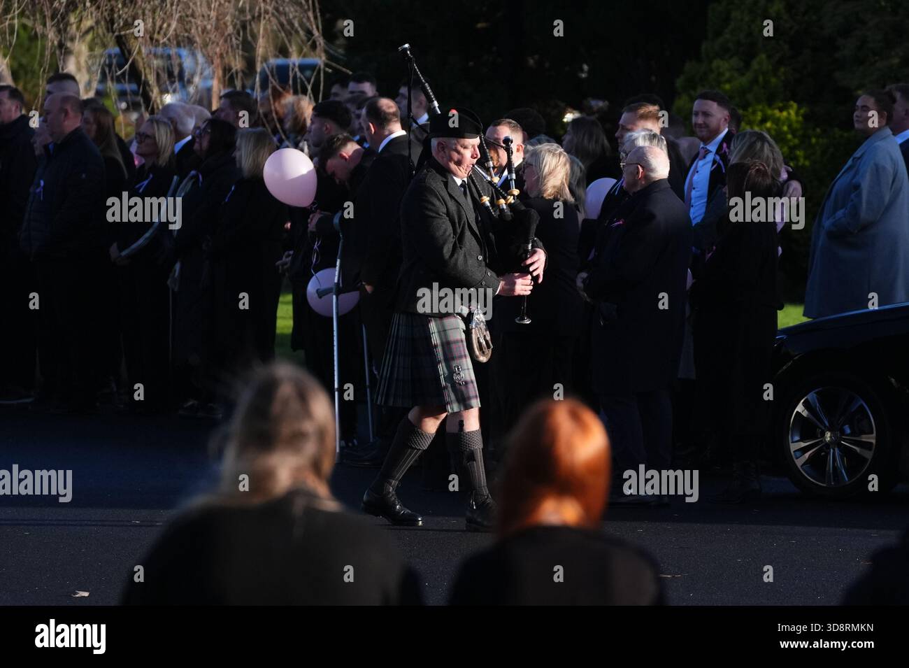 A piper plays as the coffin arrives by horse drawn hearse for the funeral of Chloe Hipson at Daldowie Crematorium in Glasgow. 21-year-old Chloe was one of five people killed when their Volkswagen Golf was in a collision with a Toyota Land Cruiser on a road near Dundalk on November 15. Picture date: Tuesday December 2, 2025. Stock Photo