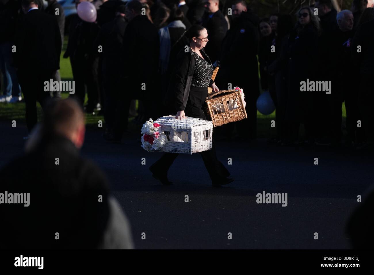 A woman arriving with doves for the funeral of Chloe Hipson at Daldowie Crematorium in Glasgow. 21-year-old Chloe was one of five people killed when their Volkswagen Golf was in a collision with a Toyota Land Cruiser on a road near Dundalk on November 15. Picture date: Tuesday December 2, 2025. Stock Photo