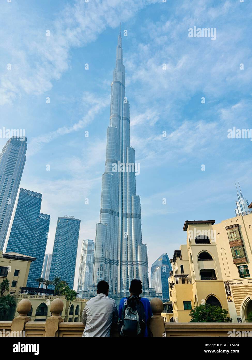 two tourists male looking at Burj Khalifa - Smartphone Captured Stock Image