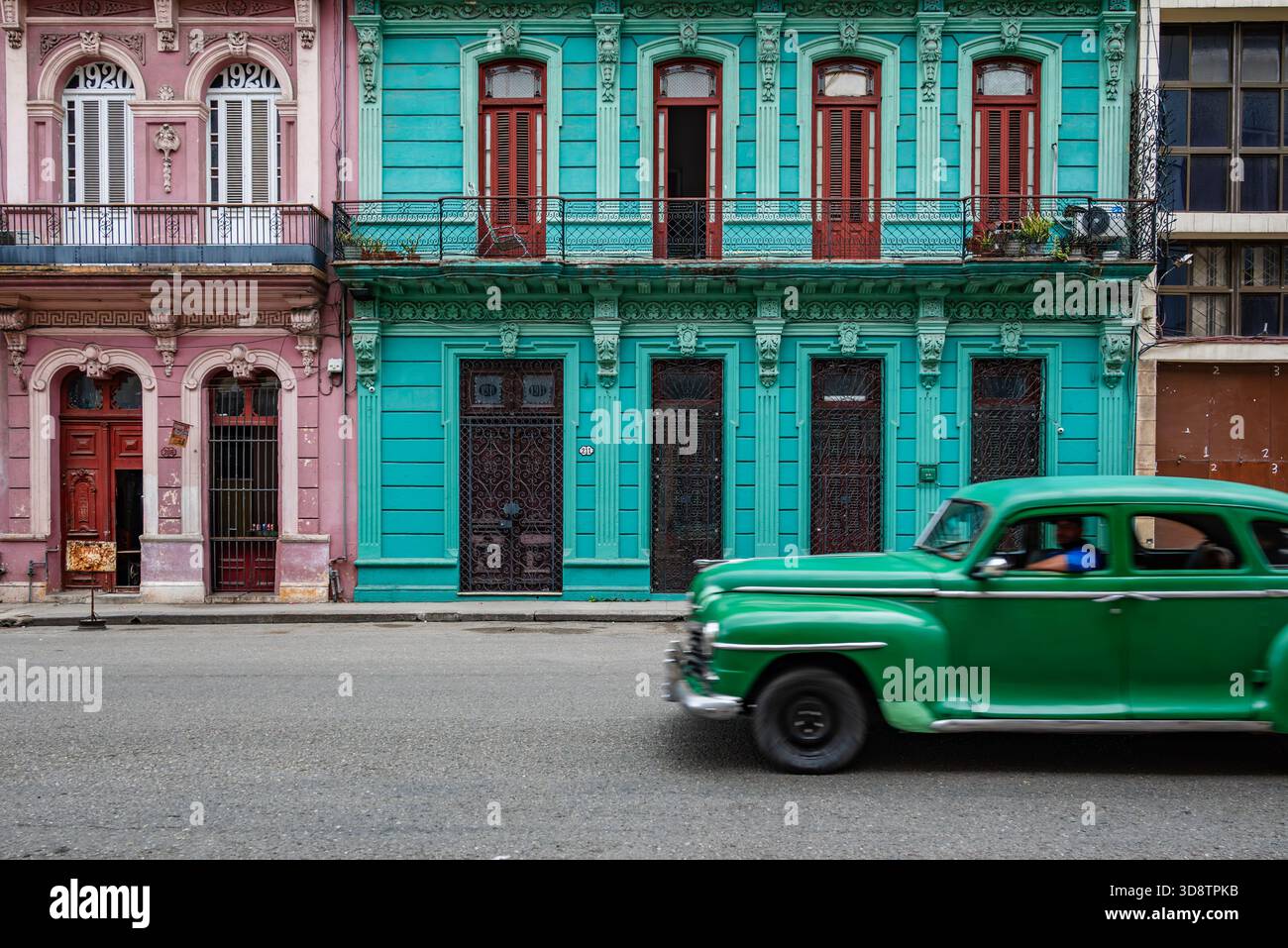 Vintage Green 1950s American Car Driving Past Colorful Colonial vintage-green-1950s-american-car-driving-past-colorful-colonial