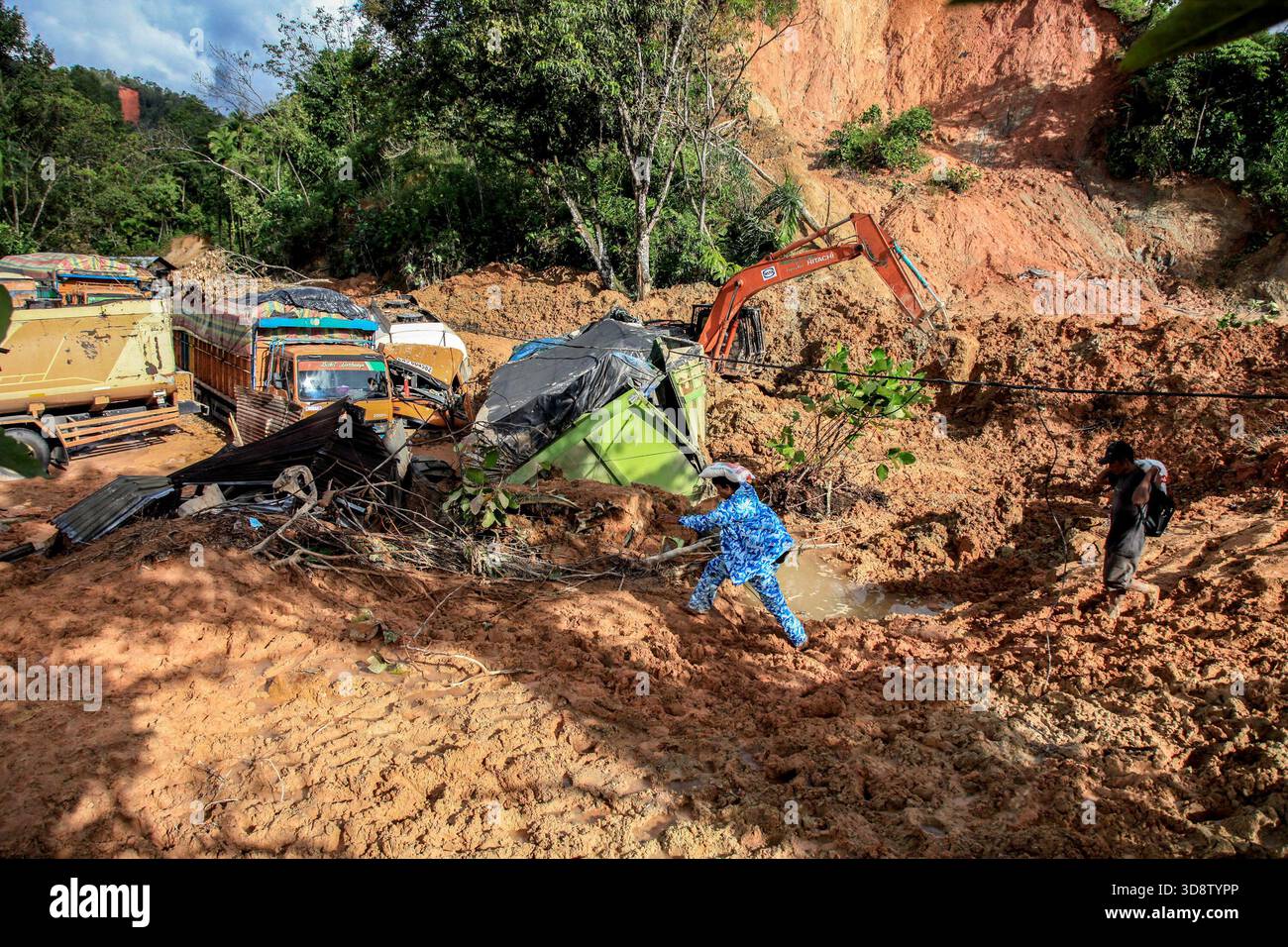 Jakarta, Indonesia. 2nd Dec, 2025. People carry disaster relief supplies at a flood-hit village in North Tapanuli Regency, North Sumatra, Indonesia, Dec. 2, 2025. The death toll from recent floods and landslides across three provinces on Indonesia's Sumatra Island has risen to 712, with 507 people still missing, the National Disaster Management Agency (BNPB) said on Tuesday. Credit: Alberth Damanik/Xinhua/Alamy Live News Stock Photo