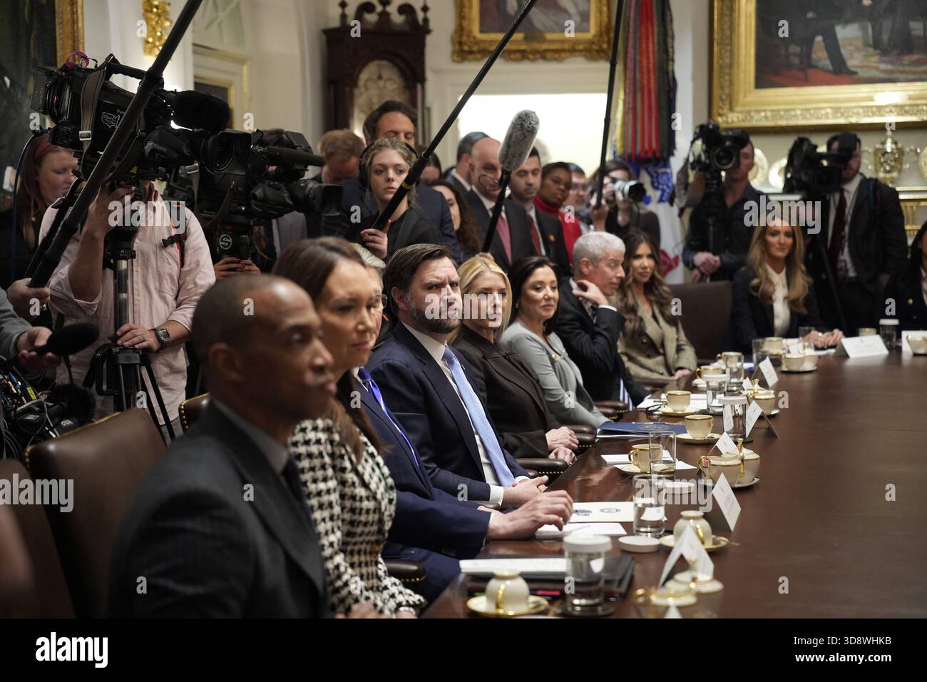 United States Vice President JD Vance, center, listens as US President ...