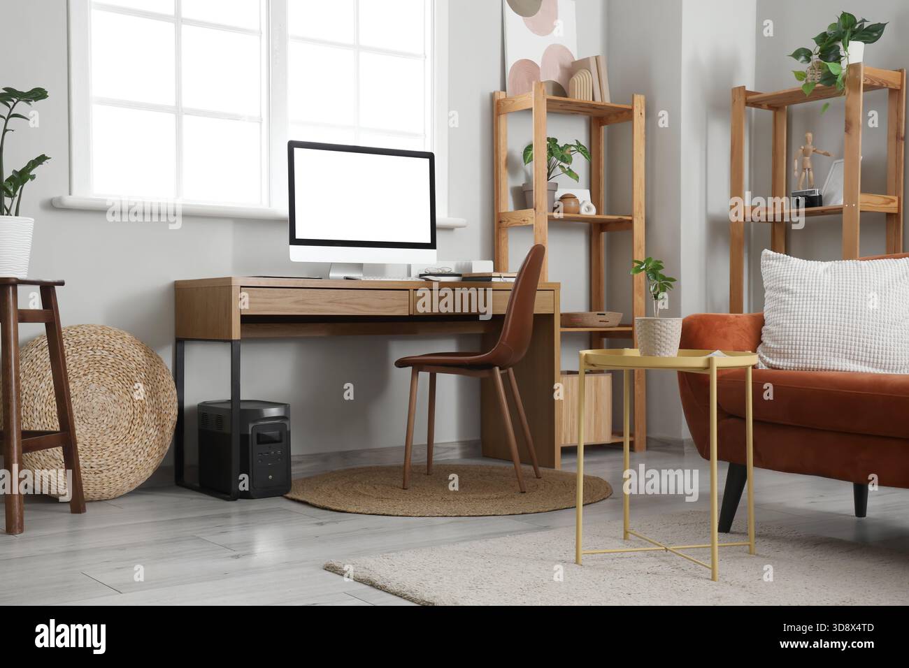 Programmer's workplace with computer and devices in living room Stock Photo