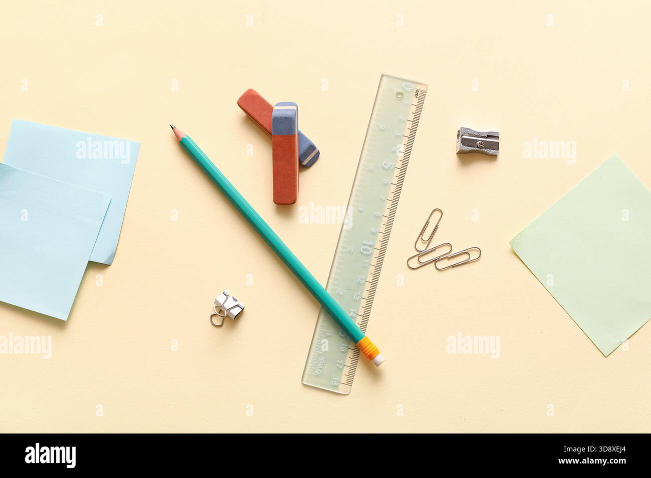 Erasers with stationery on light yellow background Stock Photo