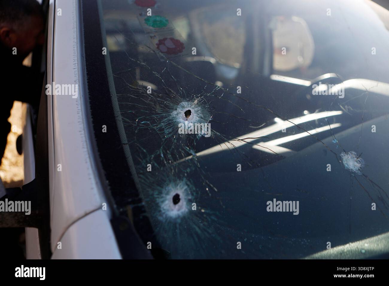 Hebron, West Bank city of Hebron. 2nd Dec, 2025. This photo shows bullet holes on the car of Muhannad Tariq Mohammad Al-Zgheer who was killed by the Israeli forces, in the West Bank city of Hebron, Dec. 2, 2025. The Palestinian Health Ministry said 17-year-old Muhannad Tariq Mohammad Al-Zgheer was shot dead in Hebron and that Israeli forces kept his body. Palestinian security officials said the shooting occurred as Israeli troops shut down northern checkpoints during a manhunt after an Israeli soldier was run over at a nearby military checkpoint. Credit: Mamoun Wazwaz/Xinhua/Alamy Live News Stock Photo