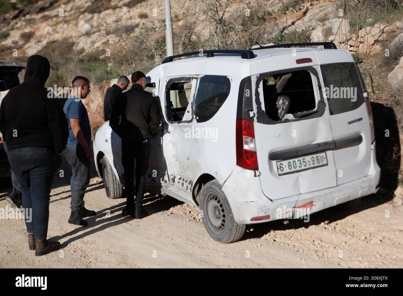 Hebron, West Bank city of Hebron. 2nd Dec, 2025. Palestinians gather around the car of Muhannad Tariq Mohammad Al-Zgheer who was killed by the Israeli forces, in the West Bank city of Hebron, Dec. 2, 2025. The Palestinian Health Ministry said 17-year-old Muhannad Tariq Mohammad Al-Zgheer was shot dead in Hebron and that Israeli forces kept his body. Palestinian security officials said the shooting occurred as Israeli troops shut down northern checkpoints during a manhunt after an Israeli soldier was run over at a nearby military checkpoint. Credit: Mamoun Wazwaz/Xinhua/Alamy Live News Stock Photo