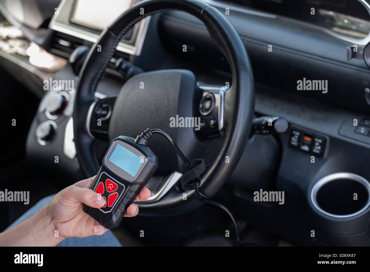 Woman using OBD2 diagnostic scanner.  Stock Photo