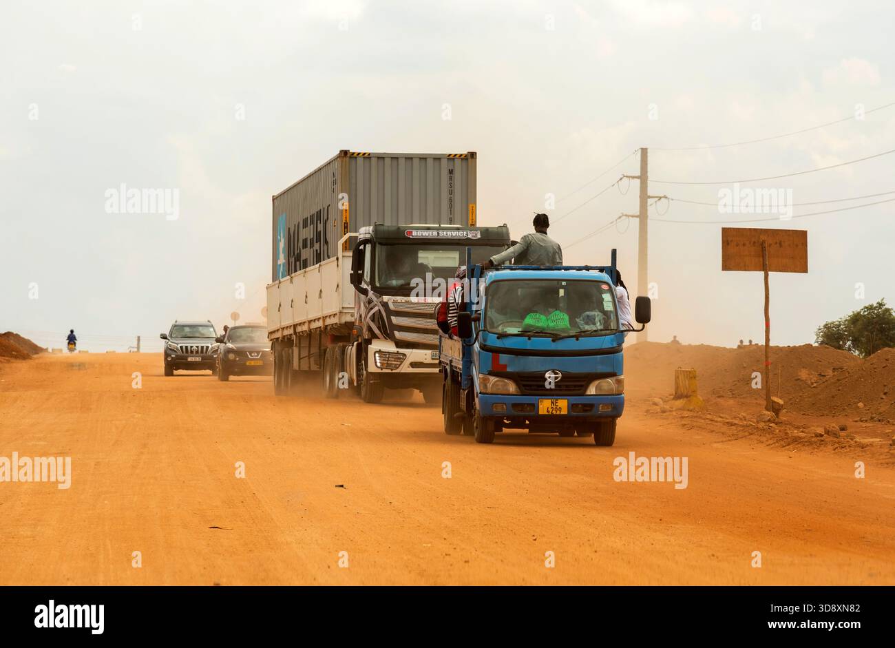 Lilongwe Malawi Africa.  09.11.2025.  Truck carrying a metal container travelling on an unmade road in Lilongwe Malaawi southern Africa. - Stock Image