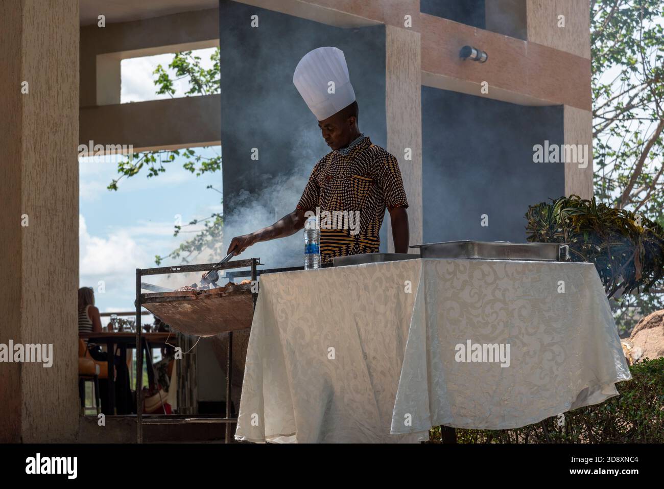 Maganga Malawi Africa.  11.11. 2025.  Chef in white hat cooking breakfast in a holiday hotel in Malawi southern Africa. - Stock Image