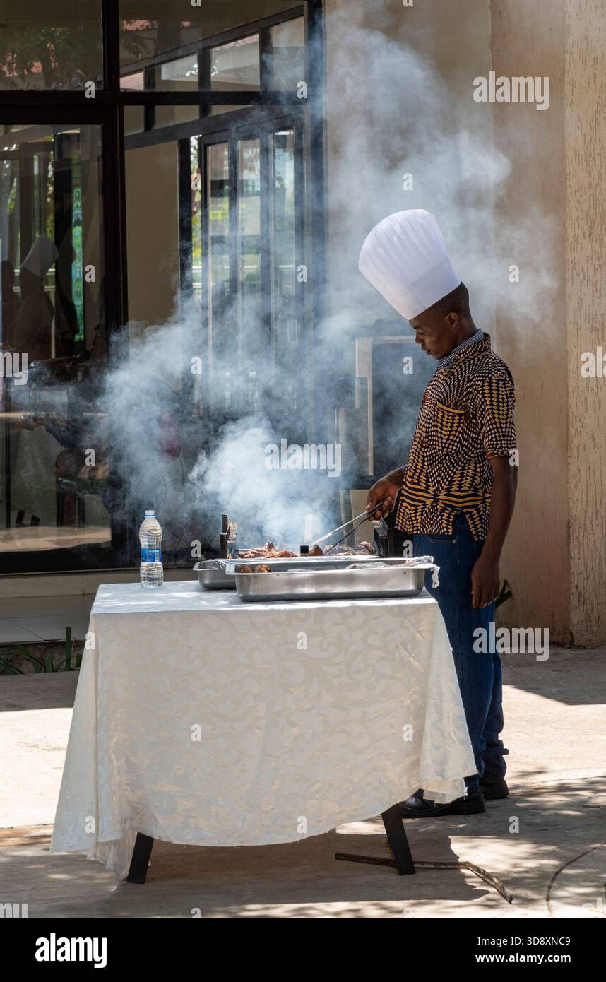 Maganga Malawi Africa.  11.11. 2025.  Chef in white hat cooking breakfast in a holiday hotel in Malawi southern Africa. - Stock Image