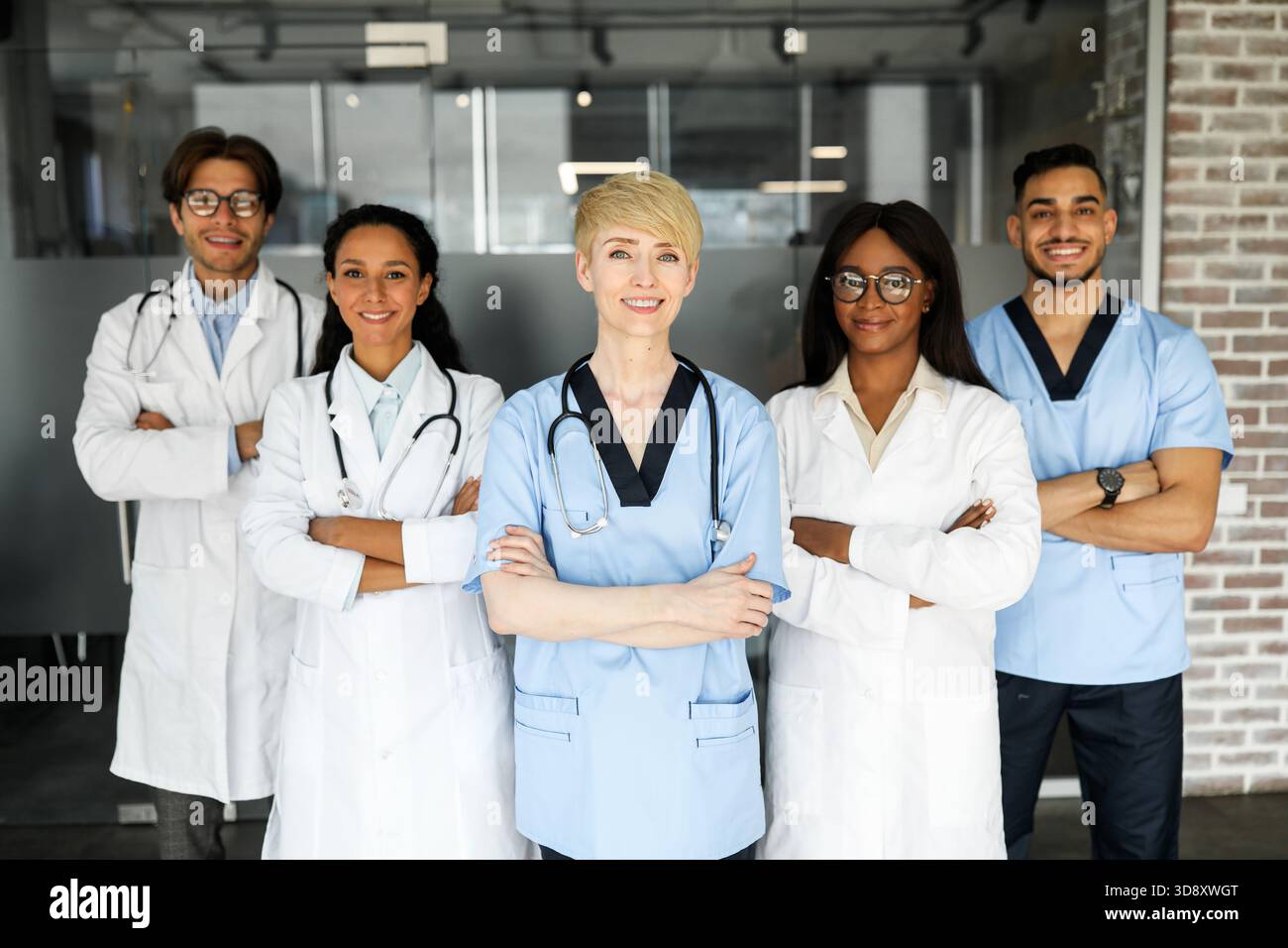 Friendly multiracial doctors team posing at hospital Stock Photo