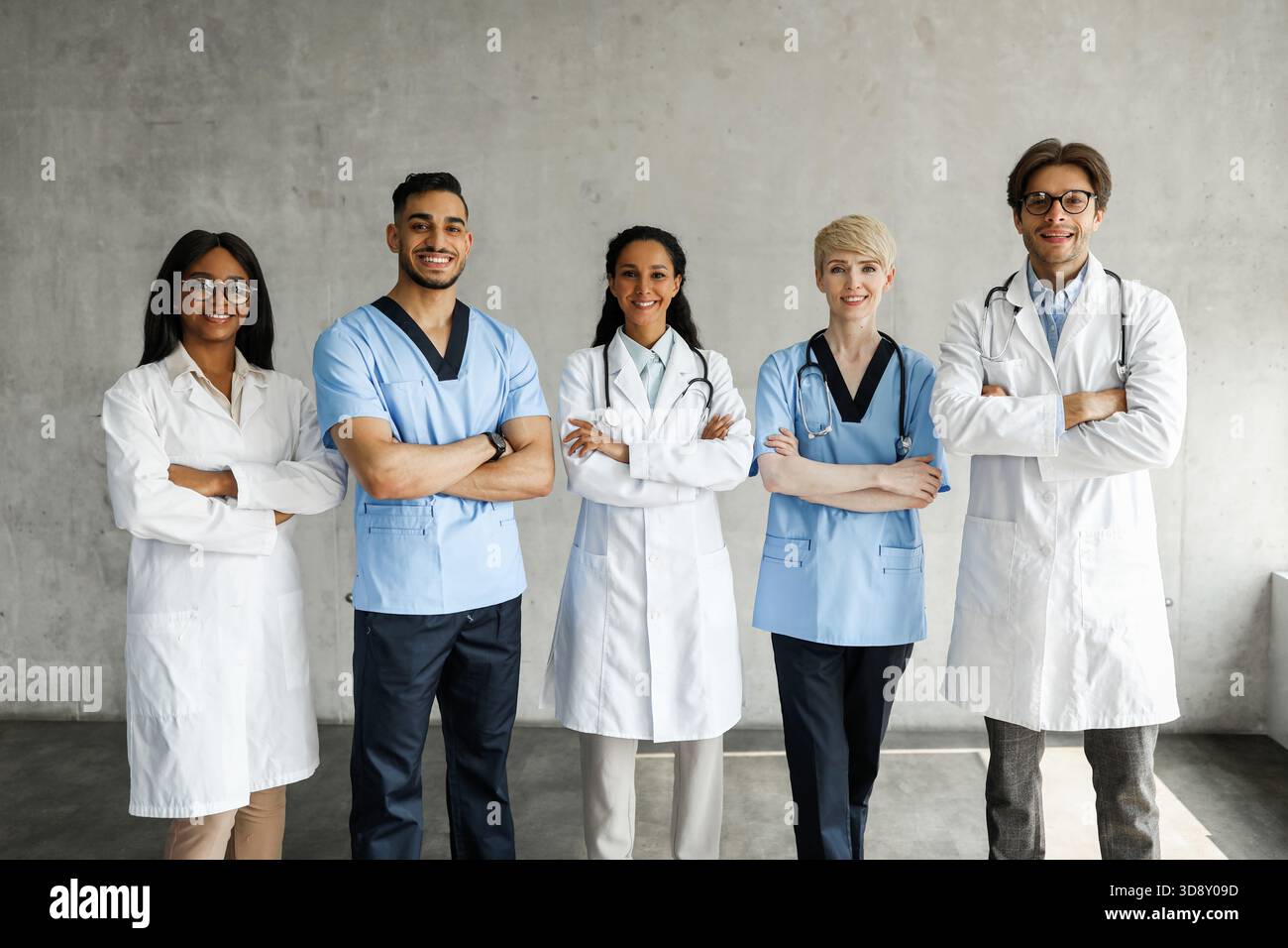 Multiracial medical team posing at clinic while having team-building Stock Photo
